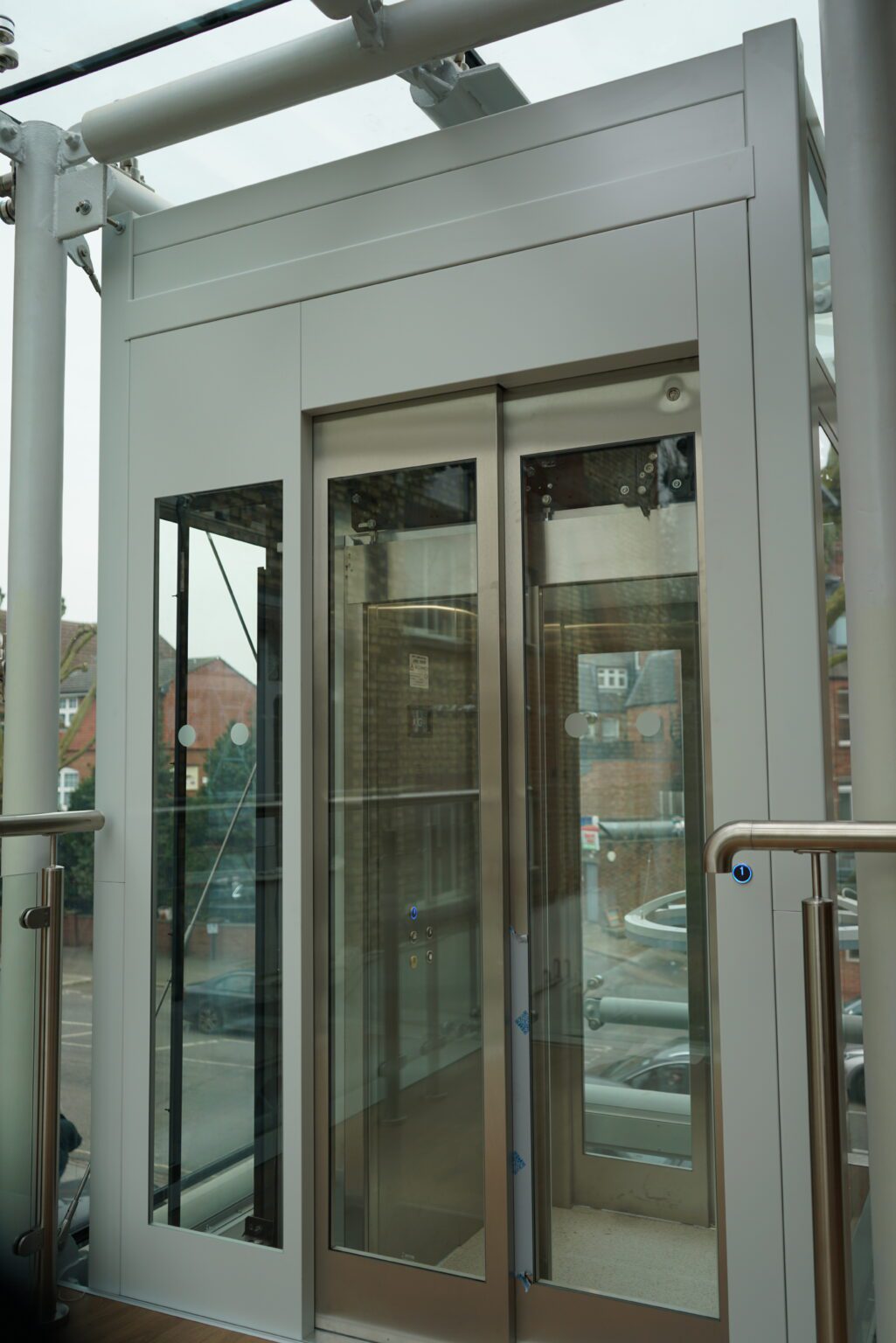 Glazed lift with framed glass doors