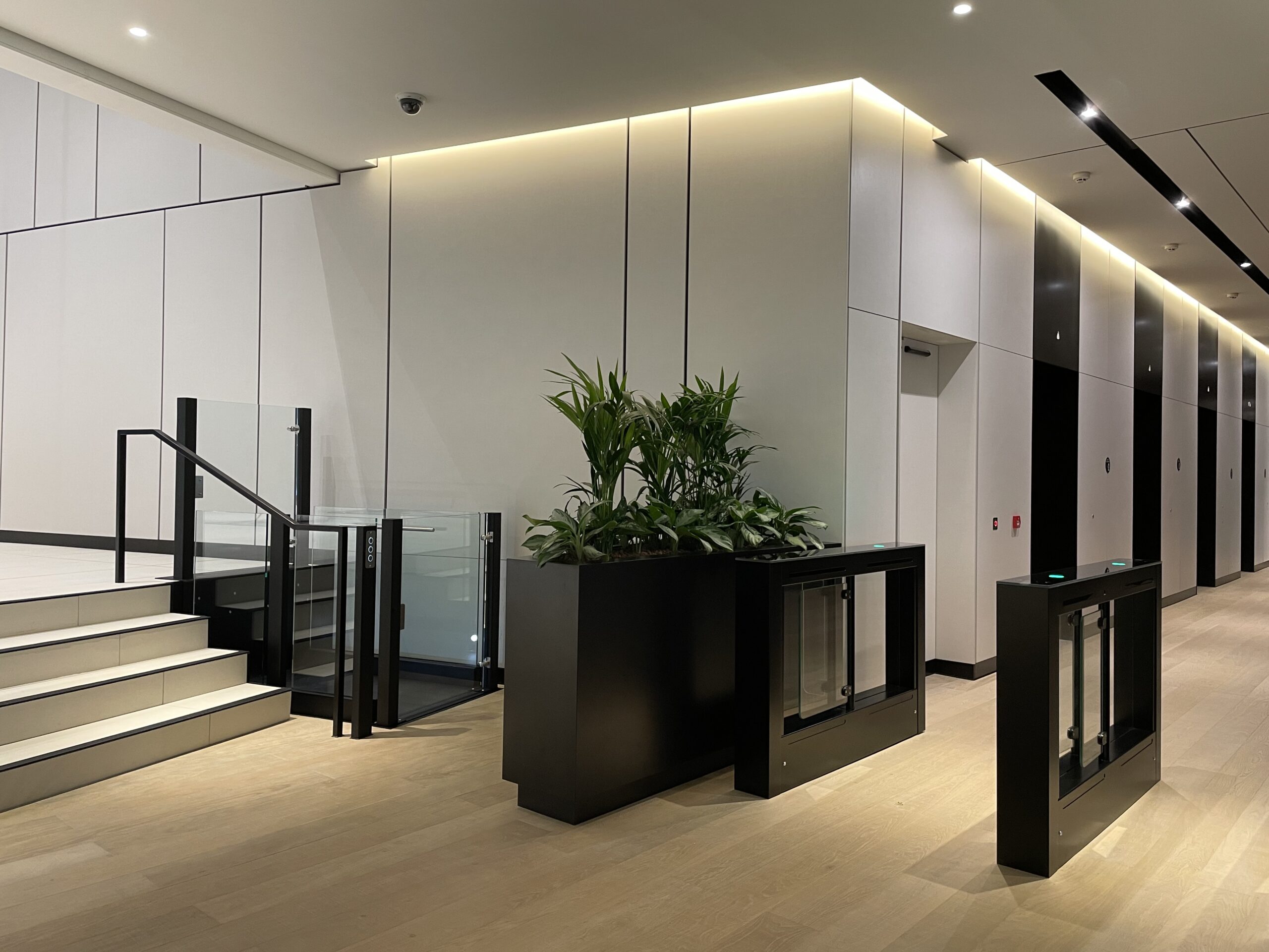 Platform lift beside the reception steps in an office foyer