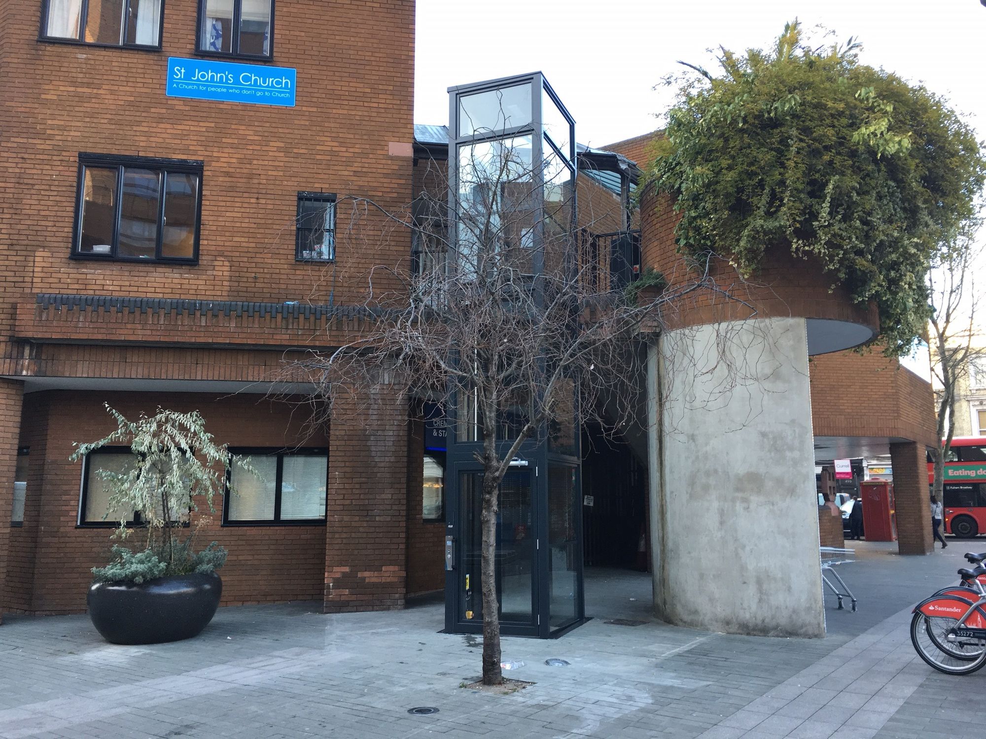 APL Hydraulic Platform Lift in a glazed self-supporting tower outside a church building