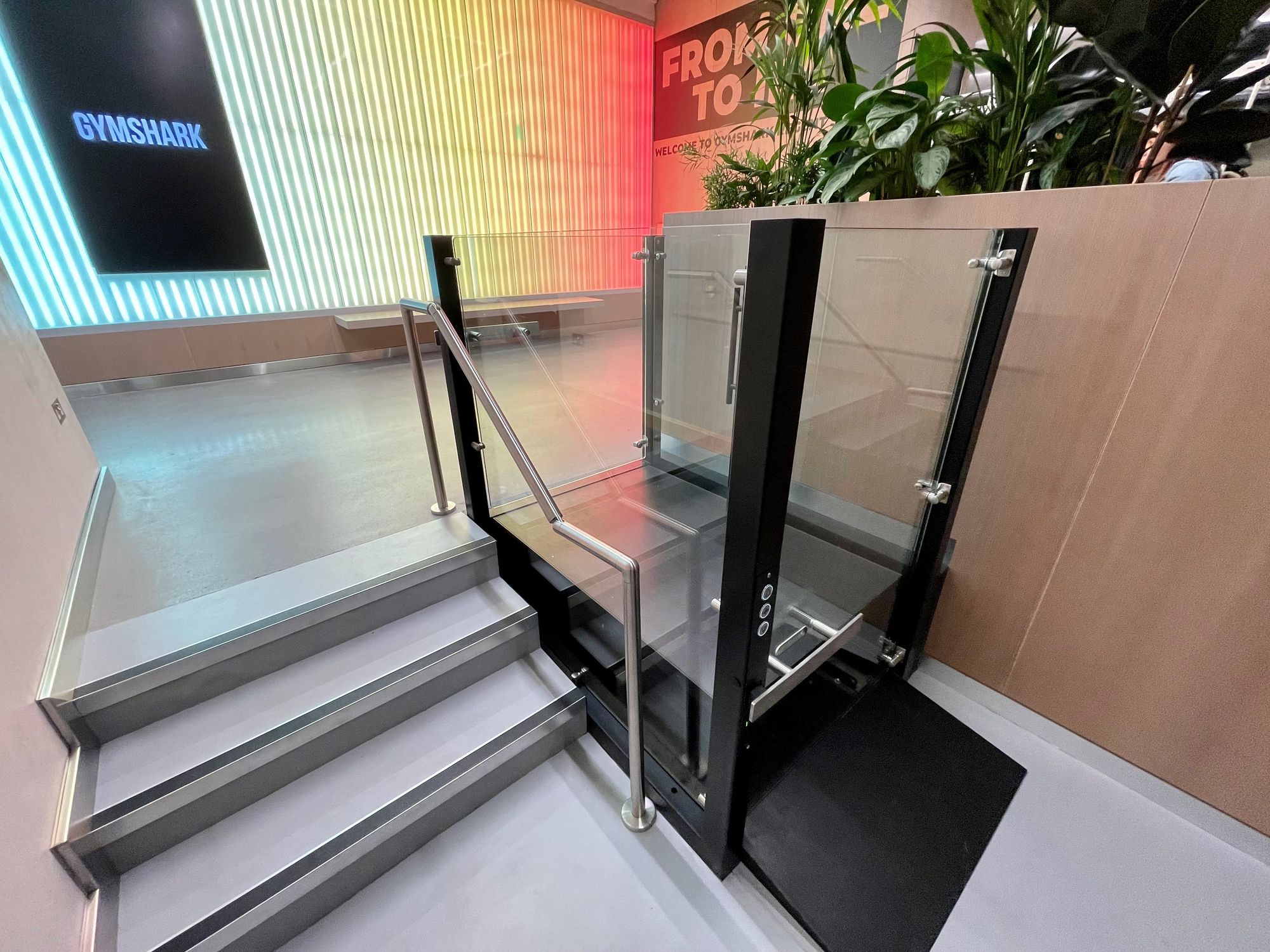 APL Prestige Platform Lift with frameless glass in a retail space
