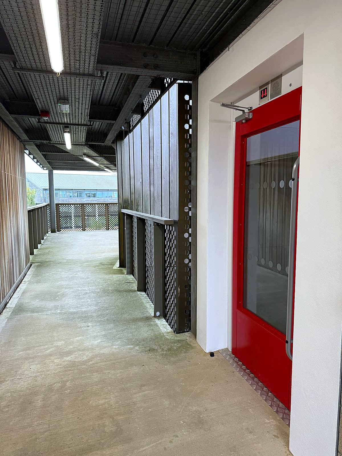 Screw-driven platform lift in a corridor