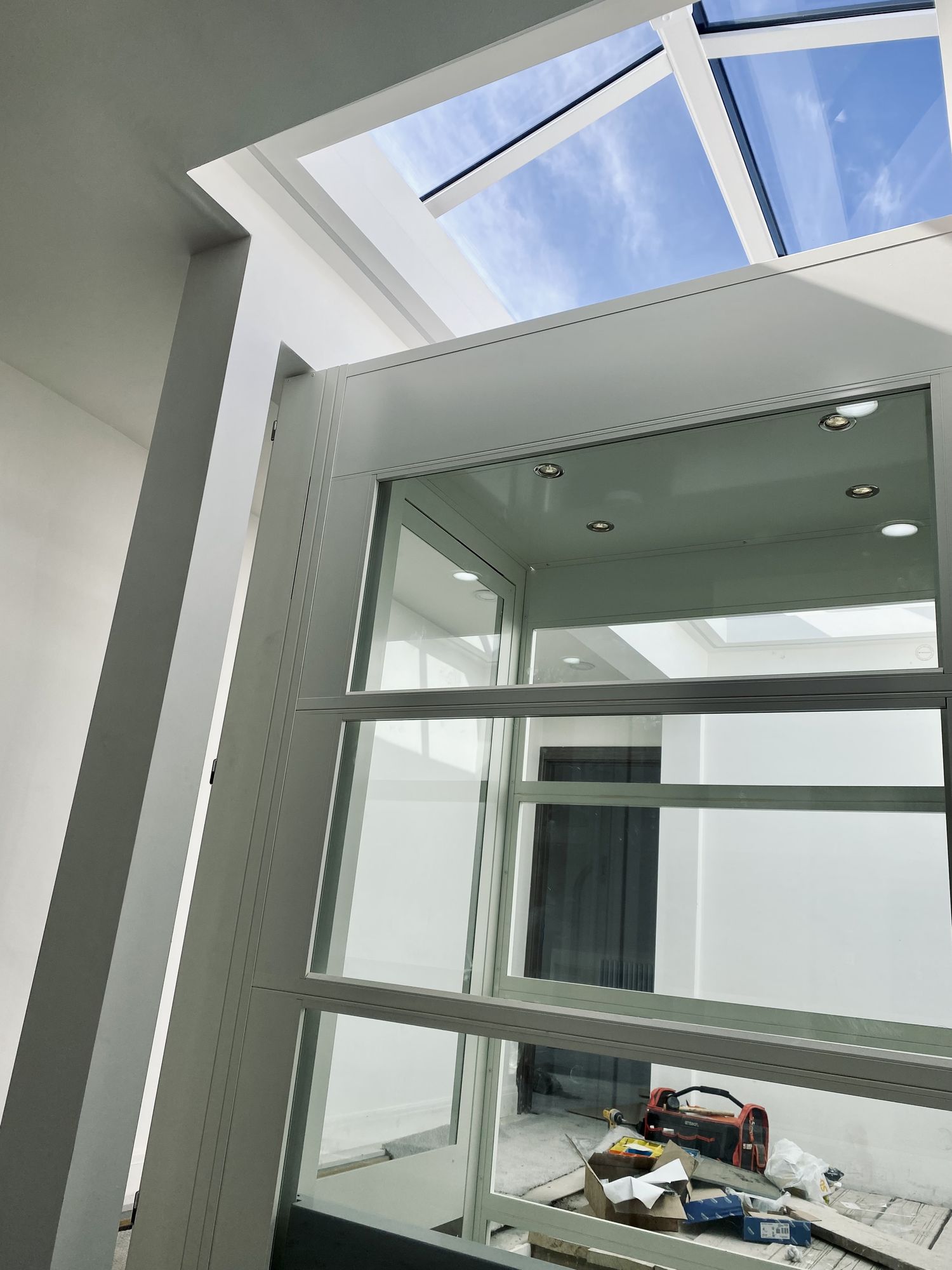 APL Traction Platform Lift in a glazed shaft under a rooflight